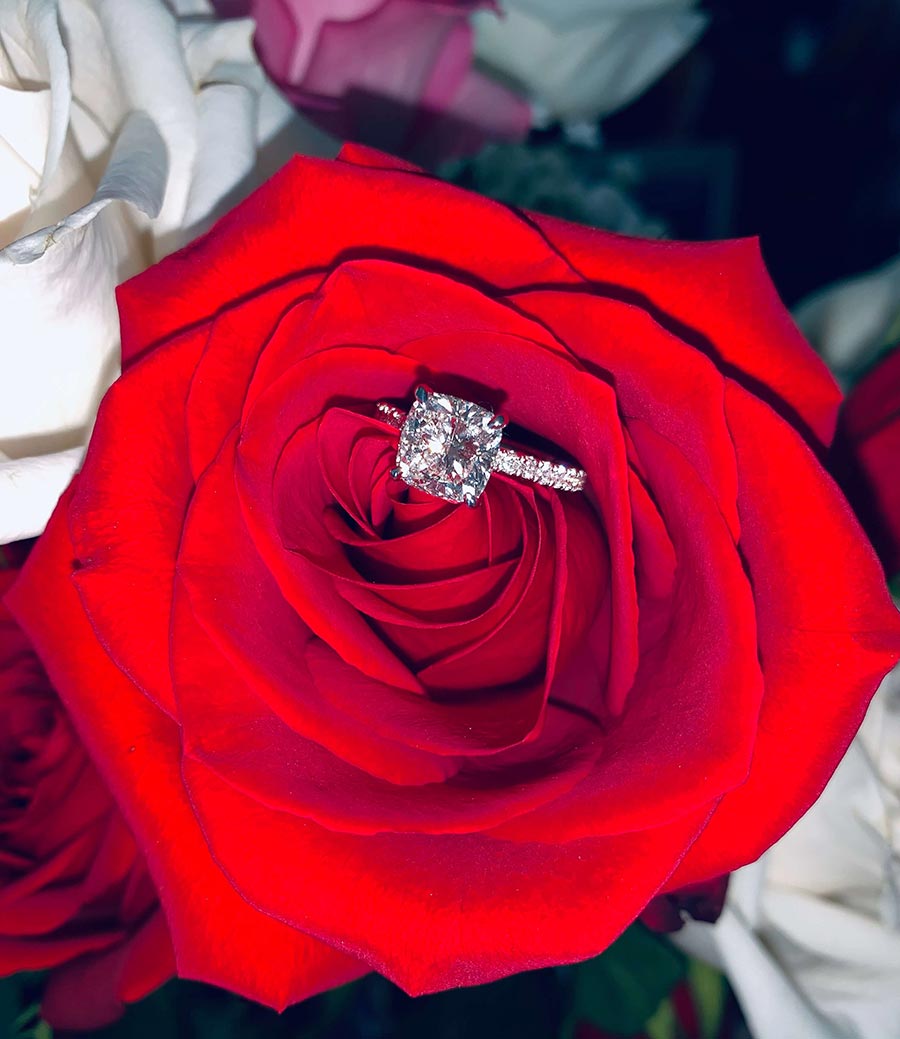 engagement ring on rose flower