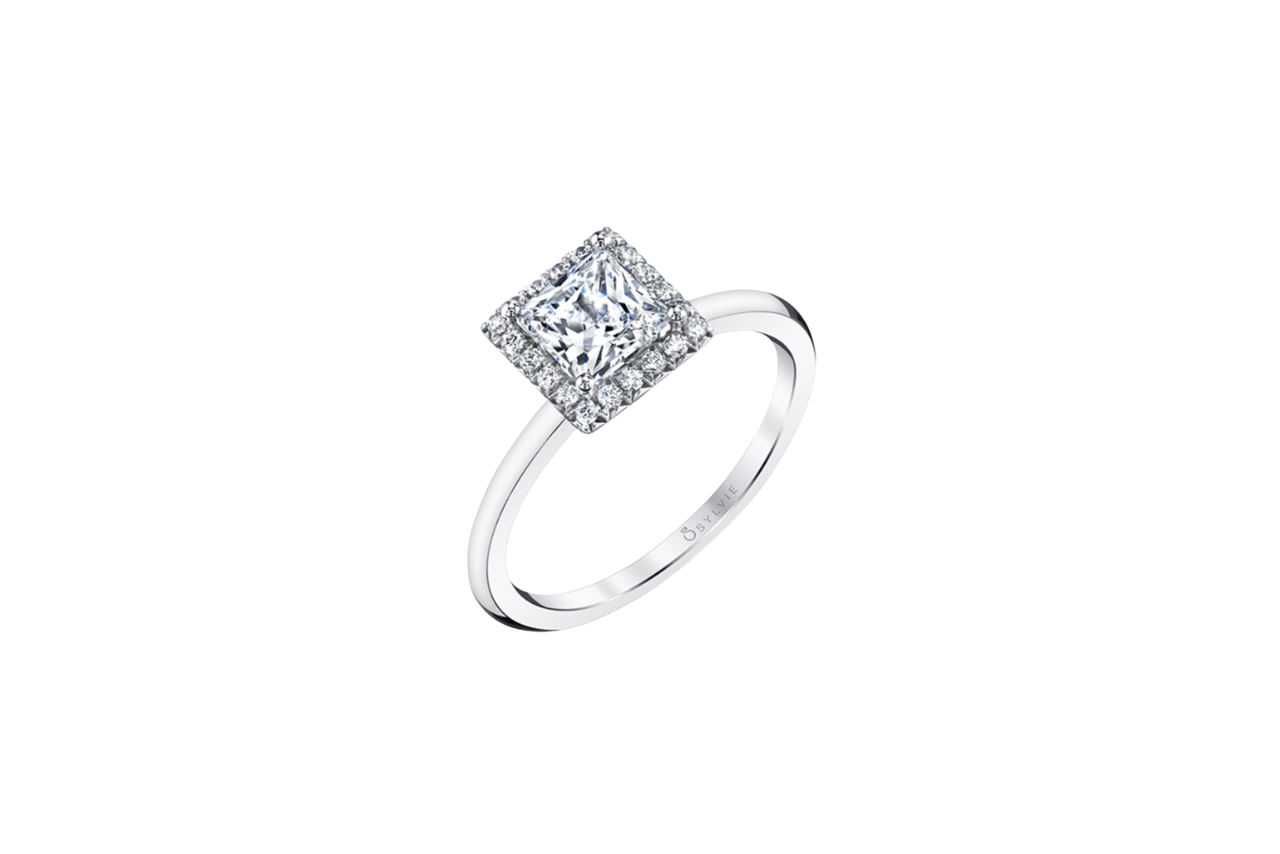 A close-up of the white gold halo engagement ring with princess cut center stone