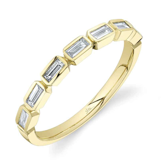 A yellow gold ring with baguette cut bezel set diamond in a &frac12; way continuity.