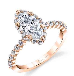 A marquise cut diamond center stone with a diamond halo and side stones along the rose gold ring