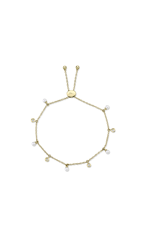Delicate gold bracelet with pearls and small circular charms