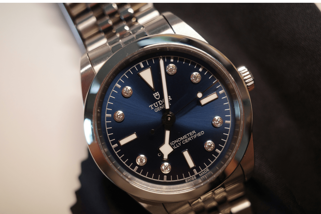 A close-up of an elegant TUDOR watch with diamond indexes. A close-up of an elegant TUDOR watch with diamond indexes.