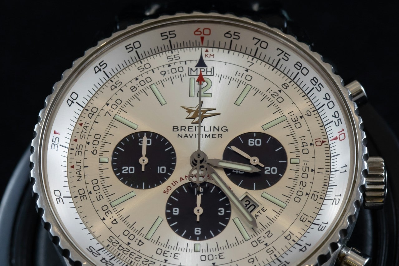 An extreme close-up of the dial of a Breitling Navitimer watch featuring multiple complications. An extreme close-up of the dial of a Breitling Navitimer watch featuring multiple complications.